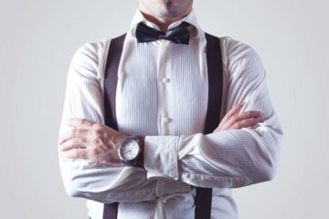 Male manager with bow tie and braces and folded arms