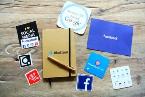 Flat lay of cardboard cut outs with various social media branding on them