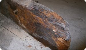 Sharp and ragged wood that has been blackened with rot before wet rot treatment is applied.